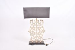 A large contemporary table lamp in the form of scrolling metalwork.