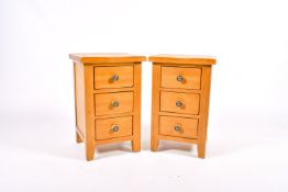 Pair of modern light oak bedside chests of three drawers. Consisting of three drawers.