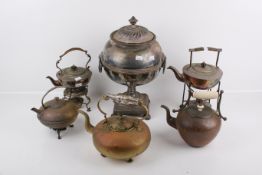 A large silverplated samovar and five kettles on stands.