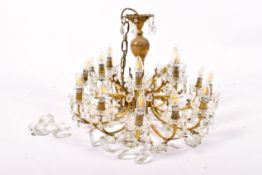 A early 20th century gilt brass and crystal 12 branch chandelier.