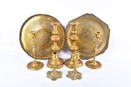 Three pairs of brass candlesticks and two brass trays.