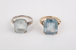 Two gold and silver blue stone rings.