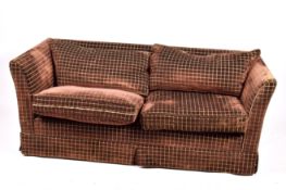 A contemporary two-seater low back sofa. Having feather cushions.