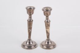 A pair of weighted silver candlesticks.