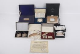 A collection of silver and white metal Concorde related items.