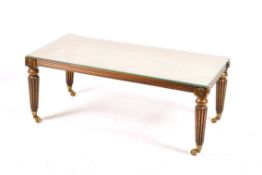 A John Tanous Limited cane top coffee table. Having fluted tapering supports with brass casters.