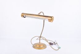 Brass banker's style desk table lamp. Raised on a circular base.