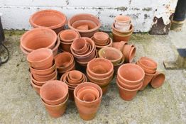 A collection of assorted terracotta garden plant pots. Of various sizes.