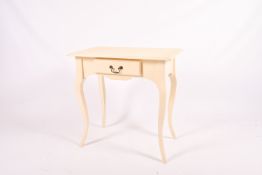 Contemporary cream painted side table with a drawer. Raised on cabriole supports.