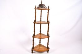 A Victorian walnut four tier waterfall style corner whatnot.