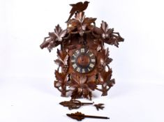 A large carved and stained wood cuckoo clock.