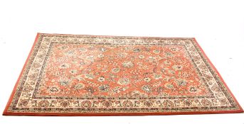 A modern Belgium made rug on a red ground. With multiple borders and floral motifs.