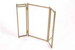 A contemporary bevel edge folding dress mirror with a brass frame. Raised on ball feet.