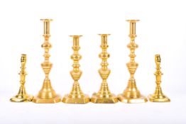 Three pairs of brass candlesticks. Largest H30cm.