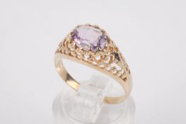 A yellow metal and amethyst ring.