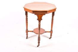 An Edwardian mahogany octagonal side table on castors.