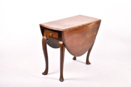 A George III mahogany oval drop leaf table.