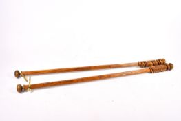 Two fluted wooden curtain poles.