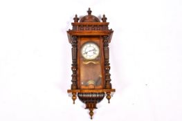 A late 19th century walnut cased Vienna style wall clock.