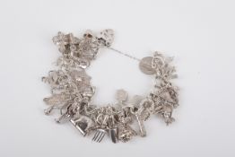 A silver charm bracelet with numerous charms.
