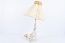 Early Lladro porcelain table lamp modelled as a seated young woman. Factory mark to base.