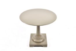 A modern grey painted circular side table with square base.