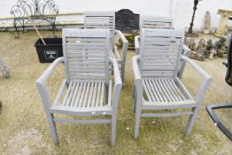 A set of four grey painted wooden garden armchairs.