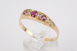 A yellow metal and ruby dress ring.