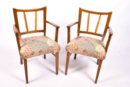 A pair of mahogany framed open armchairs.