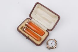 Two 9ct gold mounted cheroots and a 9ct gold watch without strap.