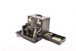 A Singer sewing machine. In the original box with accessories, box H28cm.