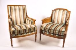 Two mahogany framed French style armchairs with contemporary striped upholstery.