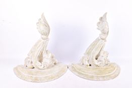 A pair of contemporary carved wall brackets. Of scrolling form, painted grey, H39cm.