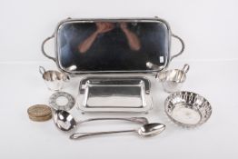 A small group of silverplated serving dishes and serving spoons.