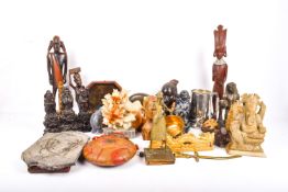 A group of miscellaneous carved wooden figures and collectables.