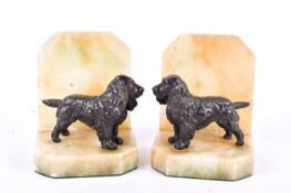A pair of 20th century onyx and resin bookends. Each featuring a cocker spaniel figure, H12.5cm.