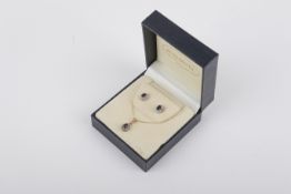 A 9ct gold, diamond and sapphire pendant and earrings set.