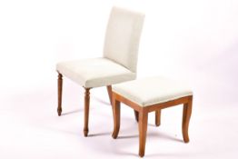 A light grey upholstered side chair and similar stool.