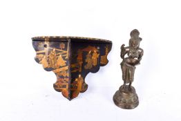 A Japanese lacquered wall bracket and a cast metal Indian deity figure.