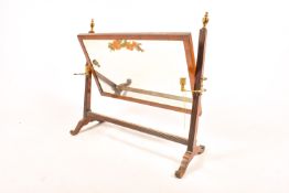 A rectangular Edwardian mahogany framed dressing table mirror with brass candle holders and finials.