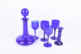 A Bristol Blue glass decanter and four wine glasses and a similar candlestick.