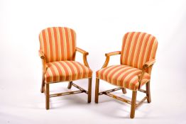 A pair of 20th century George III style open armchairs with striped upholstery.