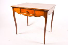 A 20th century French style writing or side table with single drawer. Raised on cabriole supports.