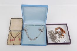 Seven silver and white metal necklaces.