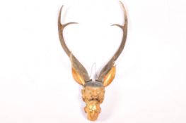 A Far Eastern carved gilt wood two headed deity.