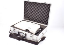 A Benq multi-media projector in an aluminium case. Serial number PDRAG00766031, remote present.