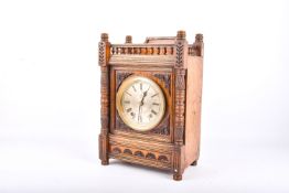 A late 19th century oak cased Aesthetic movement mantel clock. The silvered Roman dial inscribed 'T.