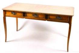 A 20th century French writing table. Three frieze drawers, blind drawers to the rear.