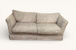 A contemporary two-seater low back sofa with spot pattern upholstery. Having feather cushions.