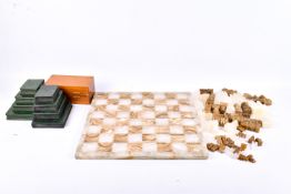 Two chess sets and a pair of bookends.